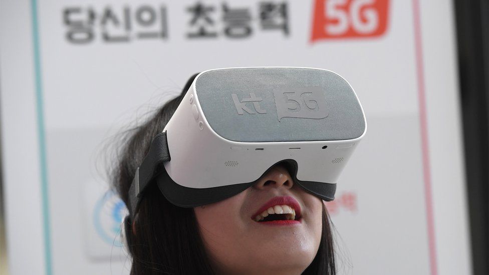 Woman uses 5G services on a virtual reality devices in Seoul in April 2019