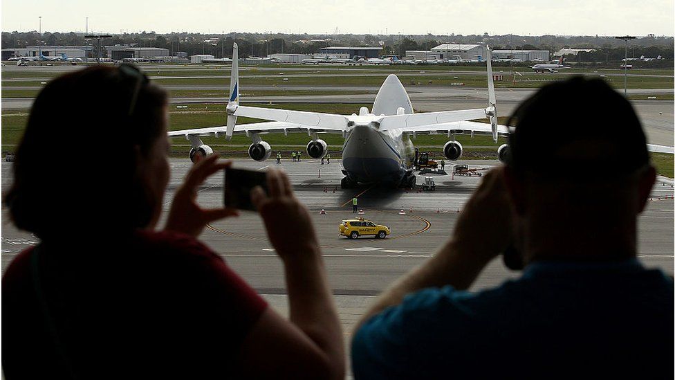 People take photos of the An-225 at Perth airport