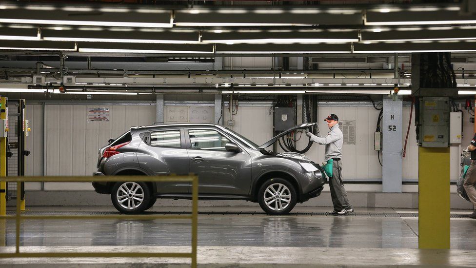 A worker with a Nissan Juke at the factory in Sunderland