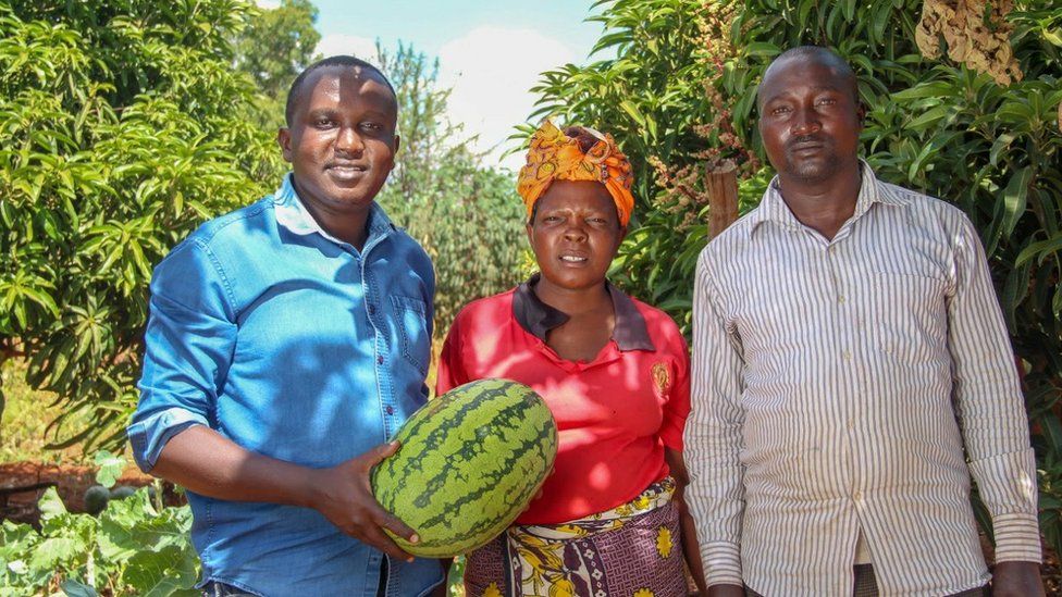 Peter Mumo with two farmers
