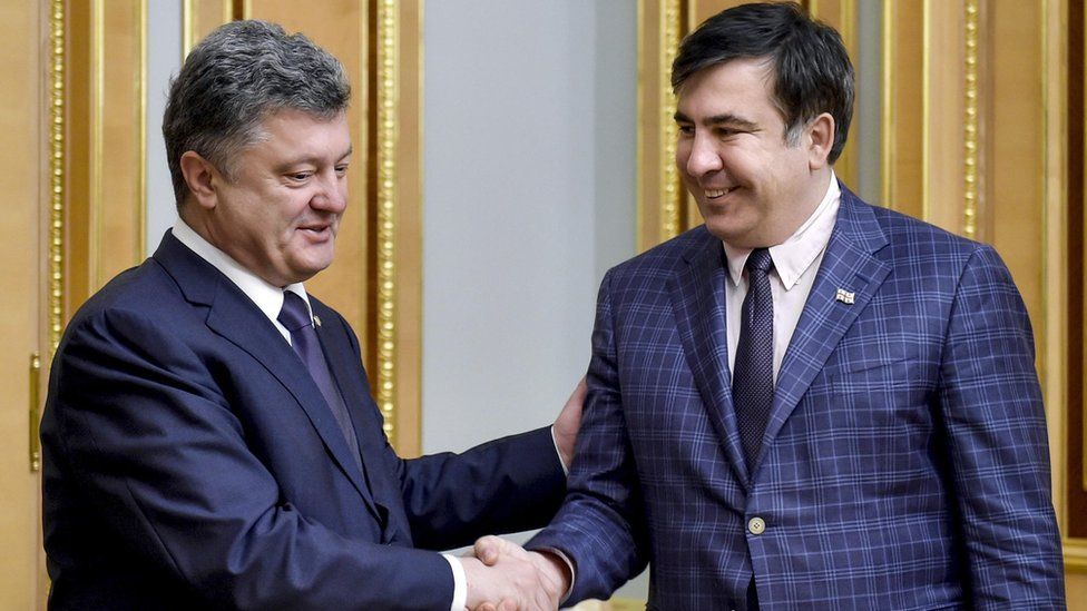 Ukraine's president Petro Poroshenko and Mikhail Saakashvili shake hands during a meeting in 1 June 2015