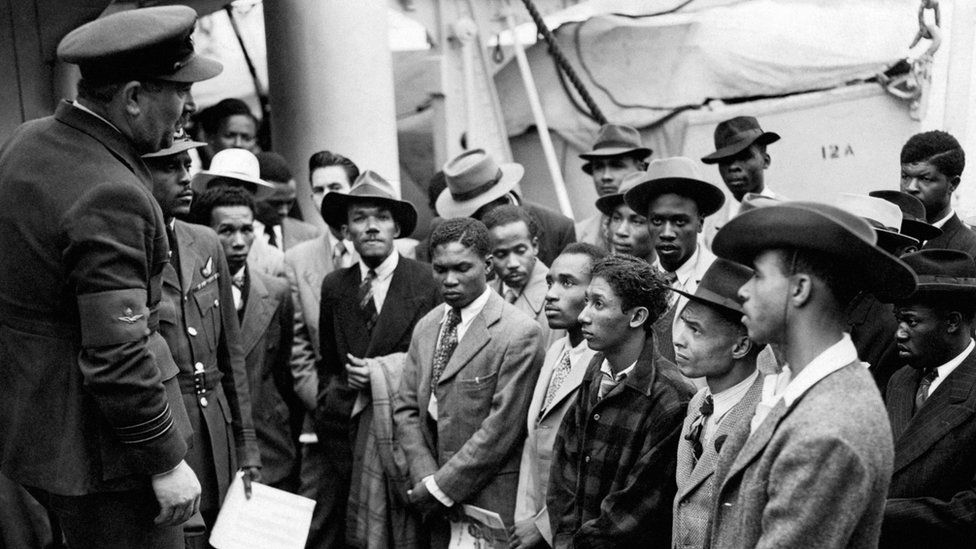 Jamaican men being welcomed by RAF officials after the Empire Windrush arrrived at Tilbury on 22 June 1948