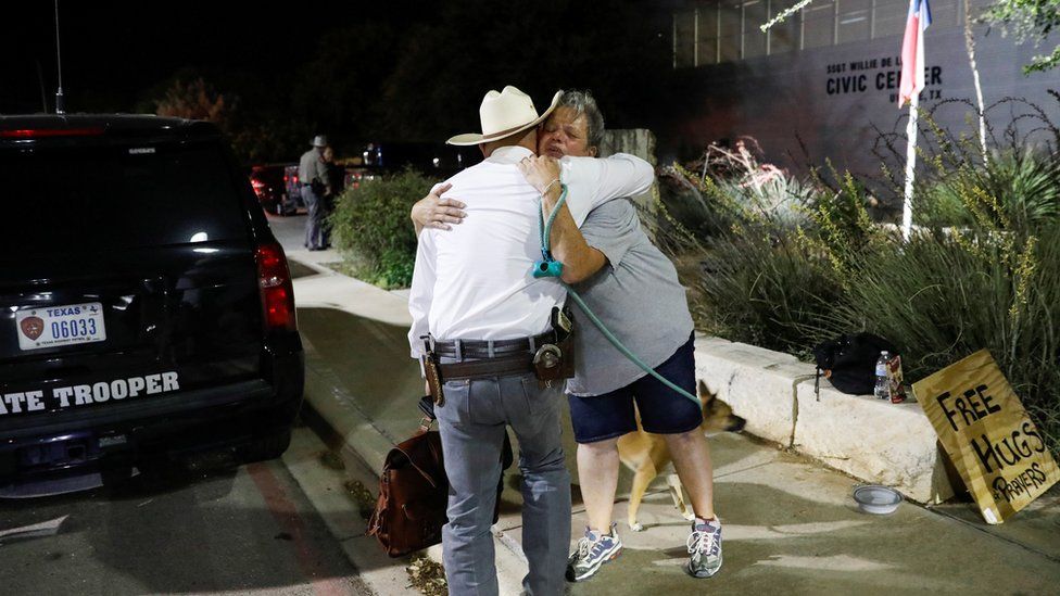 Image shows woman hugging Texas rager