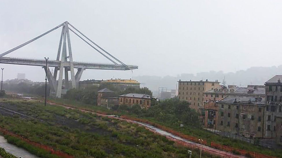 The collapsed bridge is seen over the city