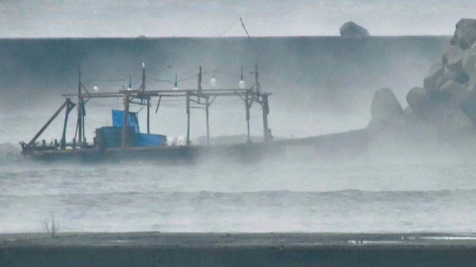 A wooden boat is seen in front of a breakwater in Yurihonjo, Akita Prefecture, Japan November 24, 2017.