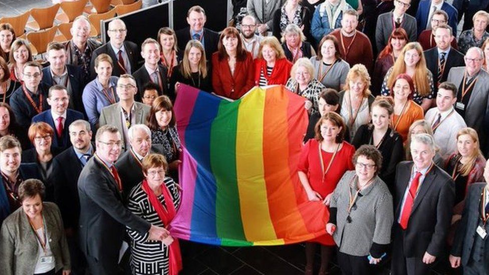 Welsh Assembly members with LGBT rainbow flag