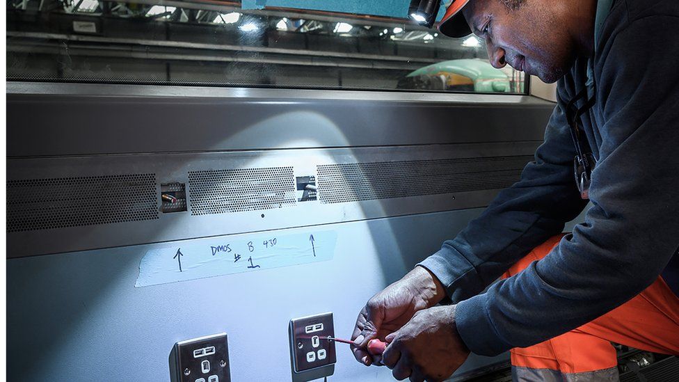 GTR fitter installs power and USB points on Electrostar train