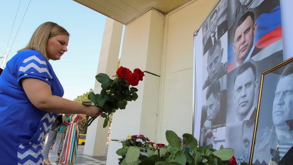 A woman places flowers to commemorate the leader of the separatist self-proclaimed Donetsk People's Republic Alexander Zakharchenko, 1 September 2018