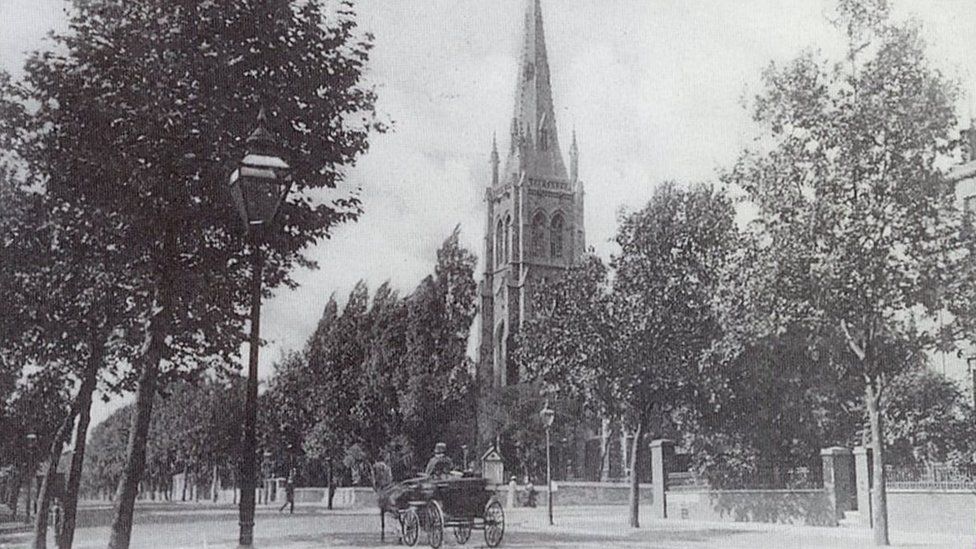 A black and white postcard showing what the church looked like in decades past