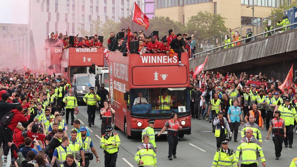 General view of Liverpool players on board open top buses during the victory parade as fans celebrate