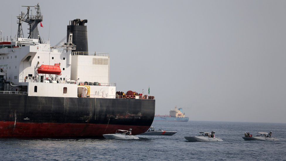 UAE Navy boats are seen next to Al Marzoqah, a Saudi Arabian tanker
