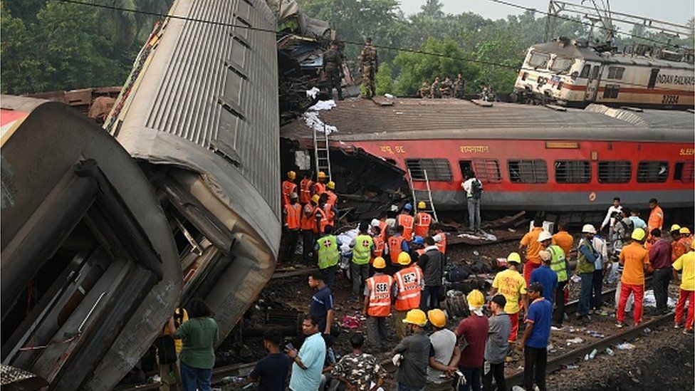 Rescuers work at the site of the train crash