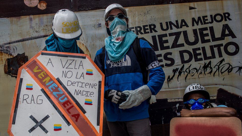 Two masked protesters known under the alias Los Pedros