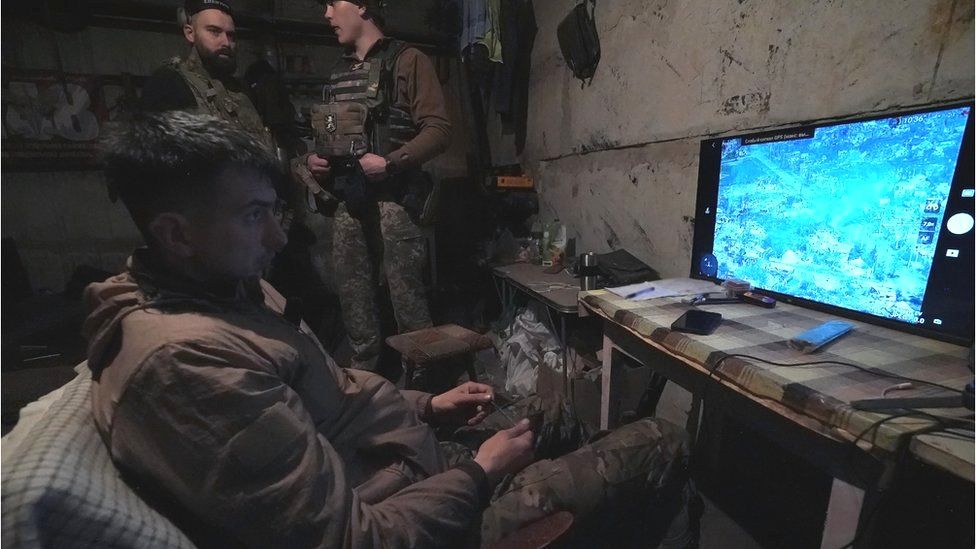 A member of the Ukrainian armed forces watches a screen showing footage from a drone above the city of Bakhmut in eastern Ukraine