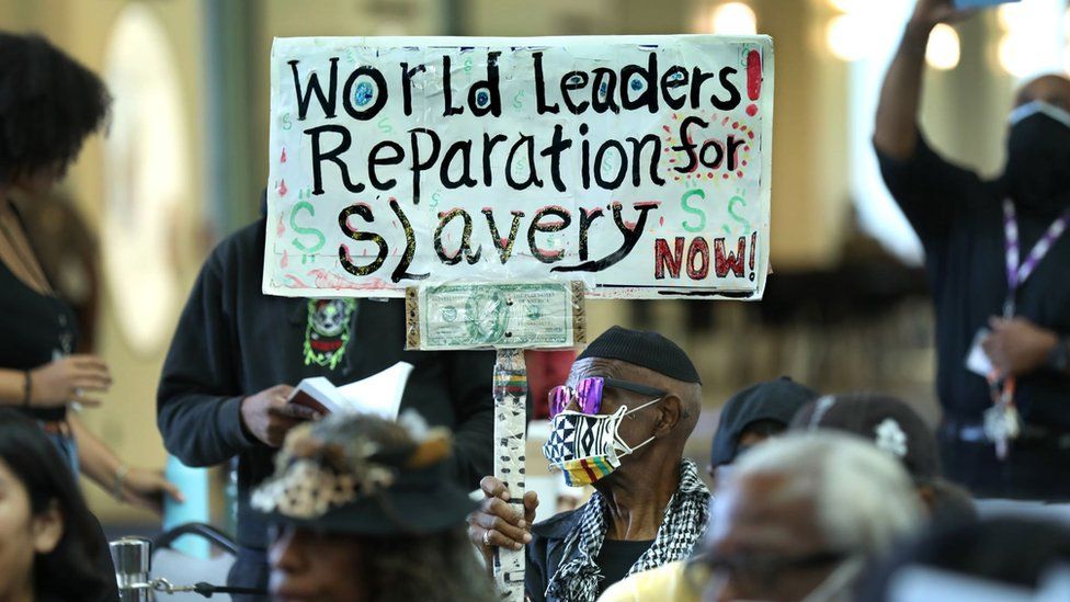 Protestors gather during reparations task force meeting.