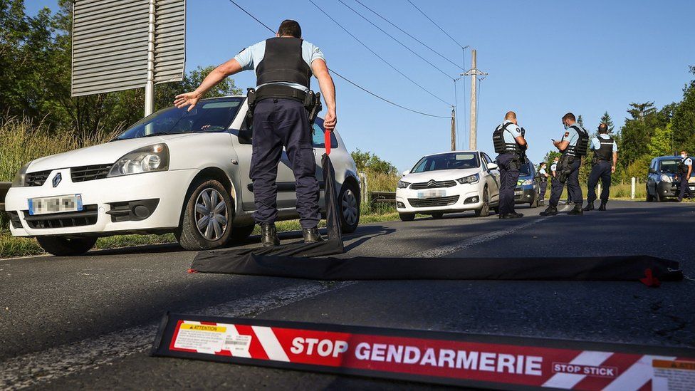 French gendarmes check vehicles during the manhunt of a heavily armed former soldier