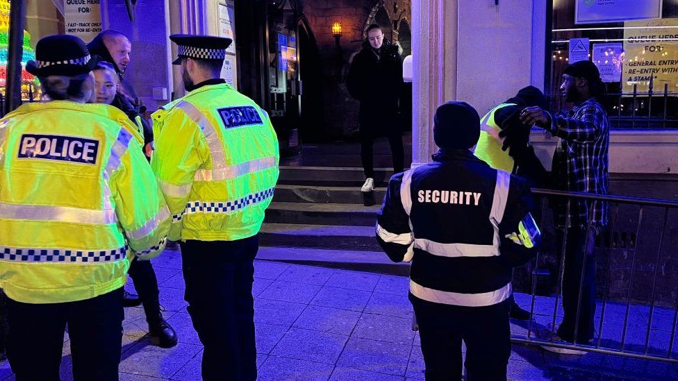 Police officers in yellow hi-viz outside a nightclub