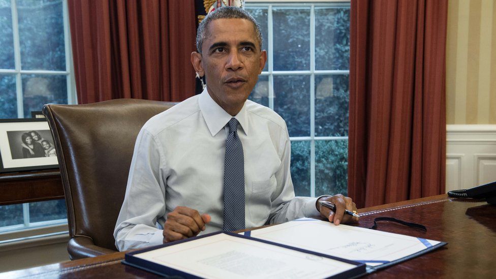 US President Barack Obama prepares to sign a $1 trillion stopgap spending bill in the Oval Office of the White House in Washington, DC, on September 19, 2014.