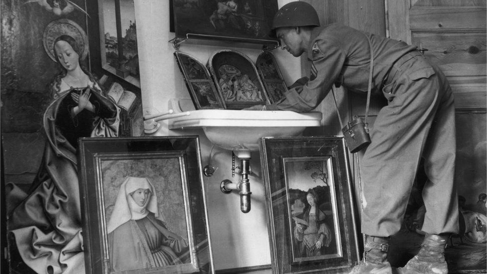 American servicemen view art treasures on show at a former Luftwaffe barracks near Konigsee - paintings looted from all parts of Europe under orders from Hermann Goering, the head of the Luftwaffe: May 1945