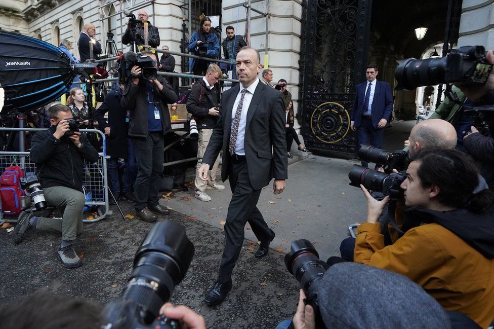 Chris Heaton-Harris walks past photographers and camera operators
