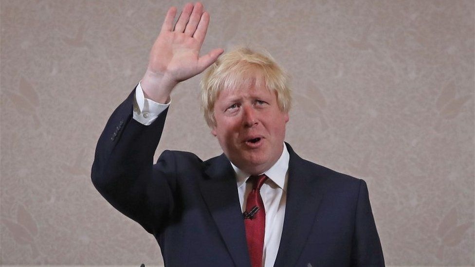 Boris Johnson waves as he announces he will not run for Conservative Party leader