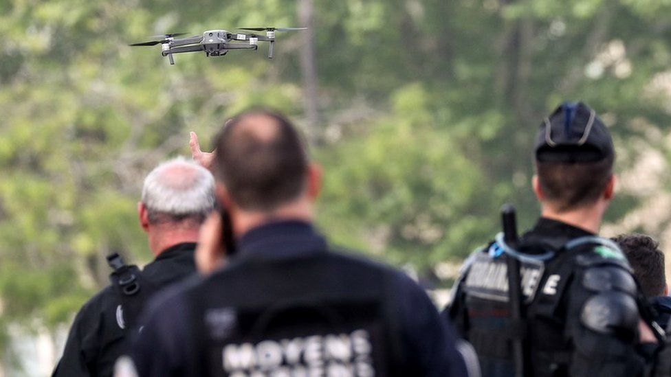 French gendarmes test a drone near the Arc de Triomphe, in the French capital, prior to the start of May Day demonstrations, in Paris on May 1, 2019