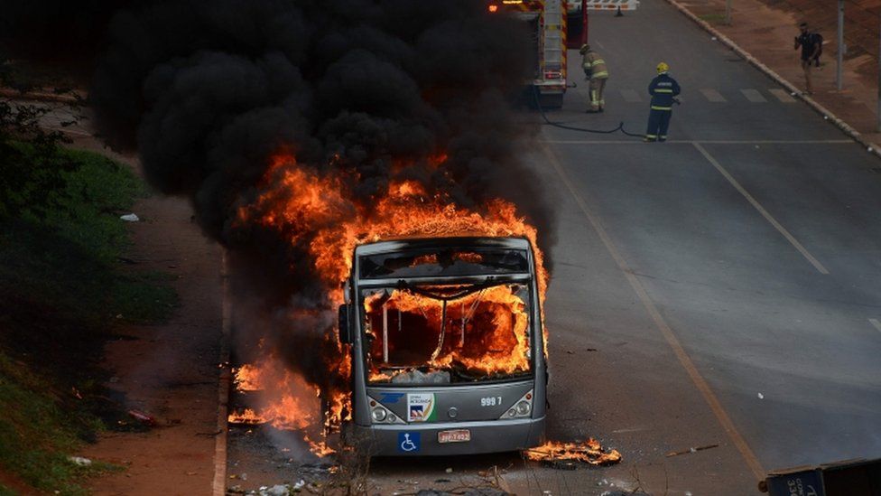 Students set buses on fire during a protest in front of the National Congress in Brasilia