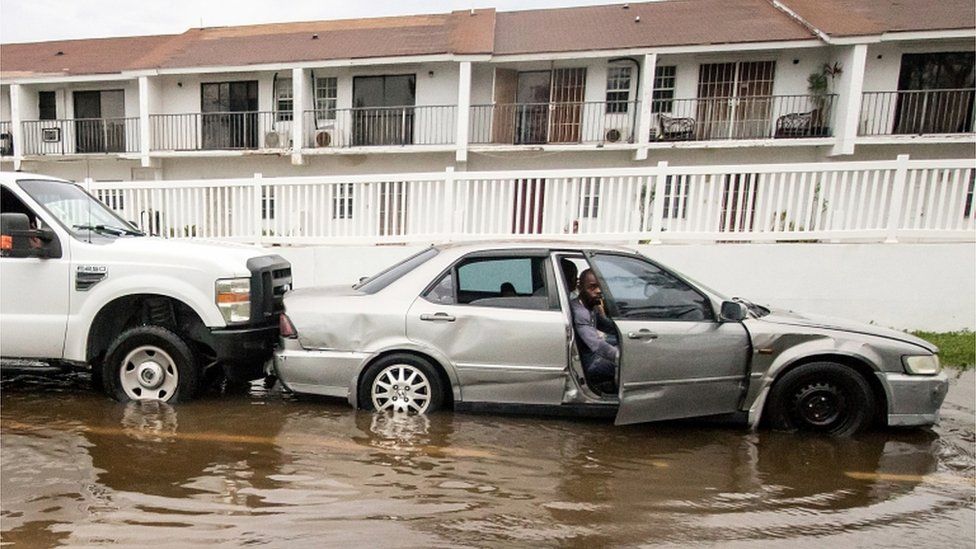 A car sits in a flooded street in the Bahamas after Hurricane Dorian, September 2019