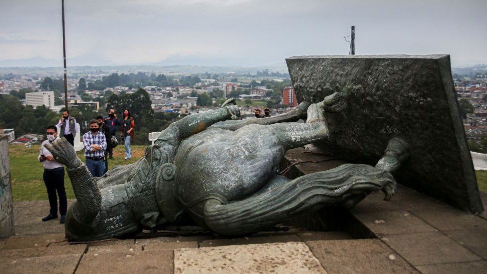 The statue of Sebastian de Belalcazar, a 16th century Spanish conqueror, lies on the ground after it was pulled down by indigenous in Popayan, Cauca department, Colombia on September 16, 2020.