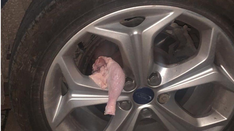 Raw chicken on a car wheel