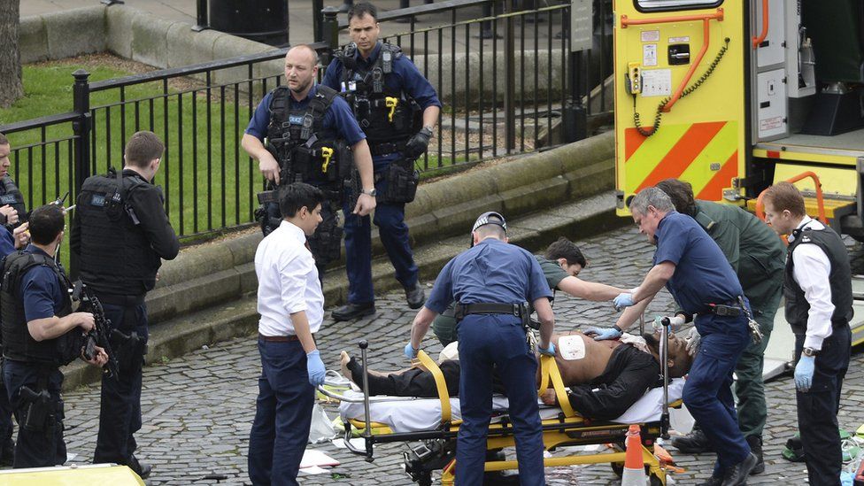 Emergency services at the scene while two knives lay on the floor outside the Palace of Westminster