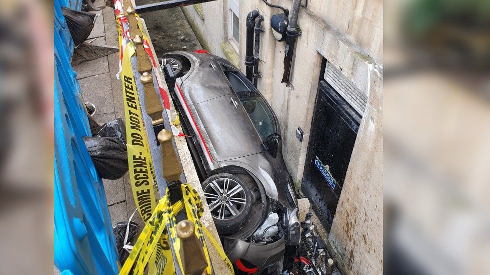 The car wedged against the Francis Hotel