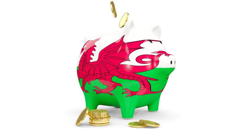 stock image of A piggy bank with the Welsh flag on it
