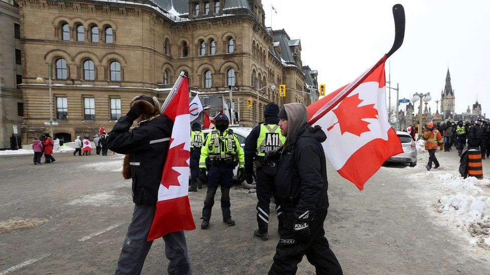 Police officers keep a watchful eye on protesters in Ottawa, 6 February