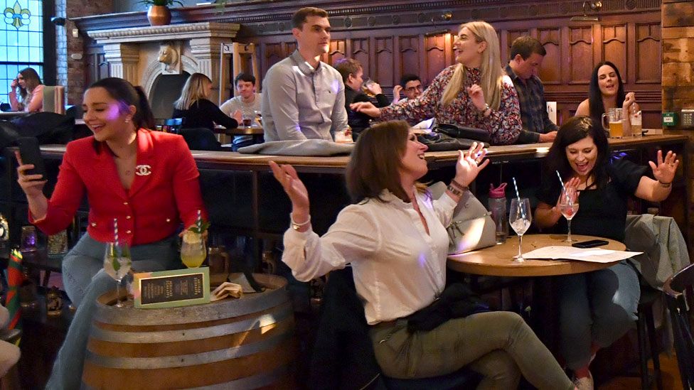 People enjoy a live show at a bar in Manchester on 17 May, following the easing of lockdown restrictions