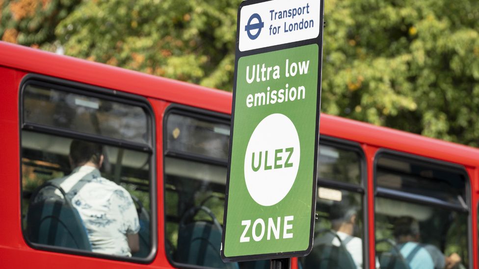 ULEZ sign and a passing bus