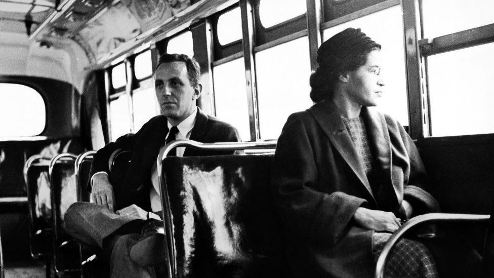 Rosa Parks sits in the front of a bus in Montgomery, Alabama, after the Supreme Court ruled segregation illegal on the city bus system on December 21st, 1956. Man sitting behind Parks is Nicholas C. Chriss, a reporter for United Press International out of Atlanta.