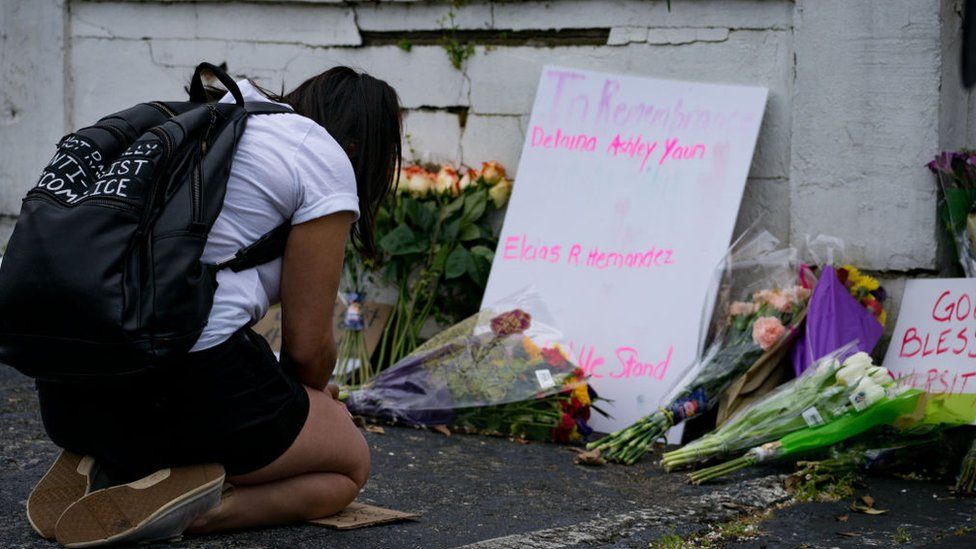 Flowers and signs adorn Gold Spa where activists demonstrated against violence against women and Asians following Tuesday night's shooting where three women were gunned down on March 18, 2021 in Atlanta, Georgia