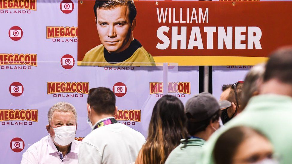 Actor William Shatner, best known for his portrayal of Captain James T. Kirk of the USS Enterprise in the Star Trek television series and movies, signs autographs for fans on the opening day of MEGACON at the Orange County Convention Center.