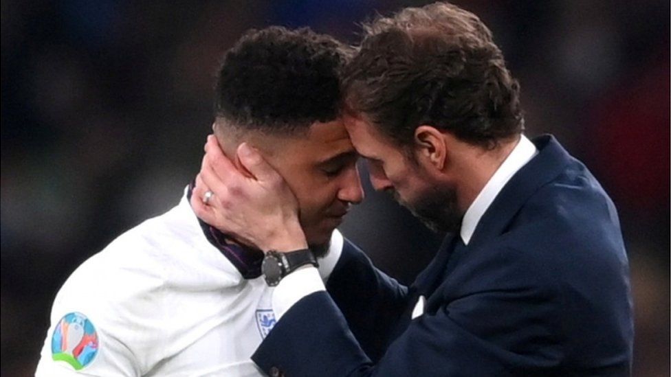 Manager Gareth Southgate comforts Jaden Sancho after his missed penalty