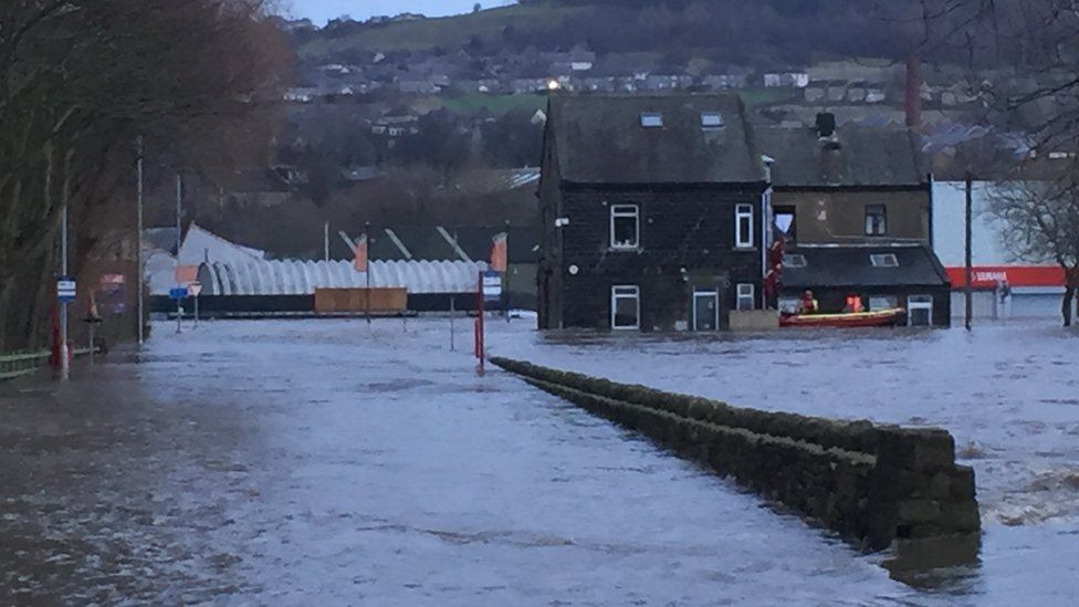 People being helped out of house in flooded part of Baildon, West Yorkshire, on 26 December 2015