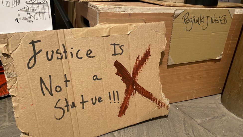 Statue made at the workshop - it reads 'Justice is not a statue'