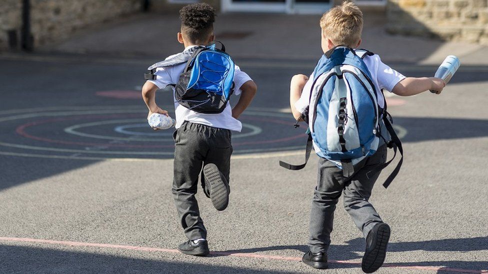 Boys running in schoolyard