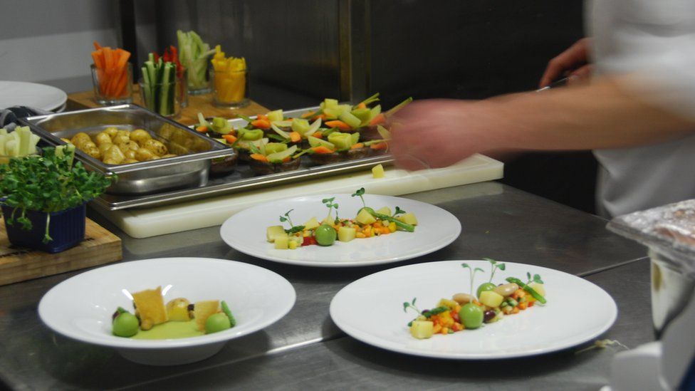 chef serving food onto plates