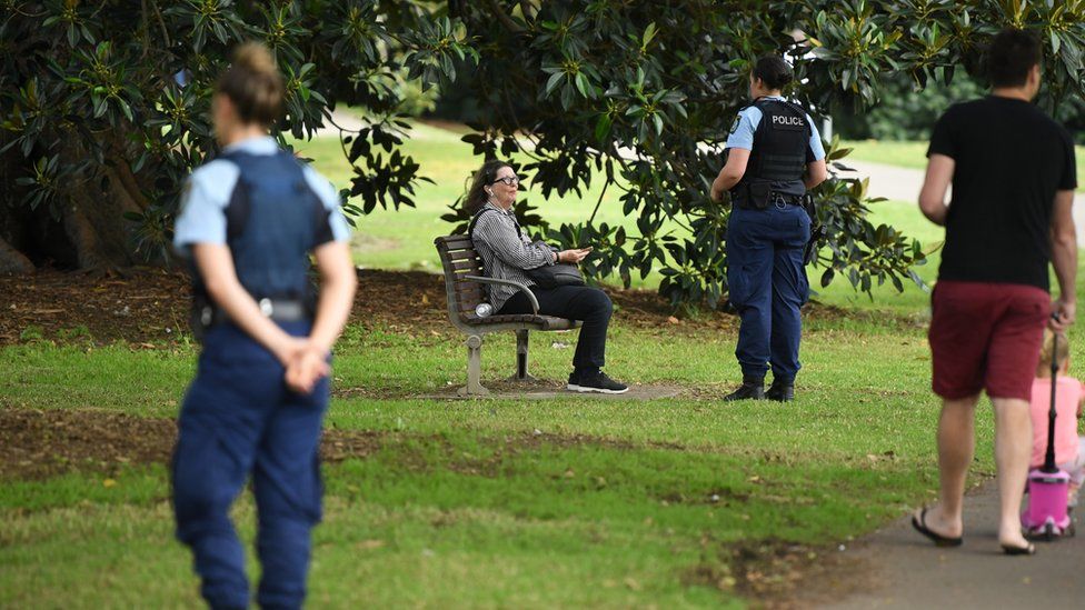 Australian police in a Sydney park approach visitors and ask them to move on