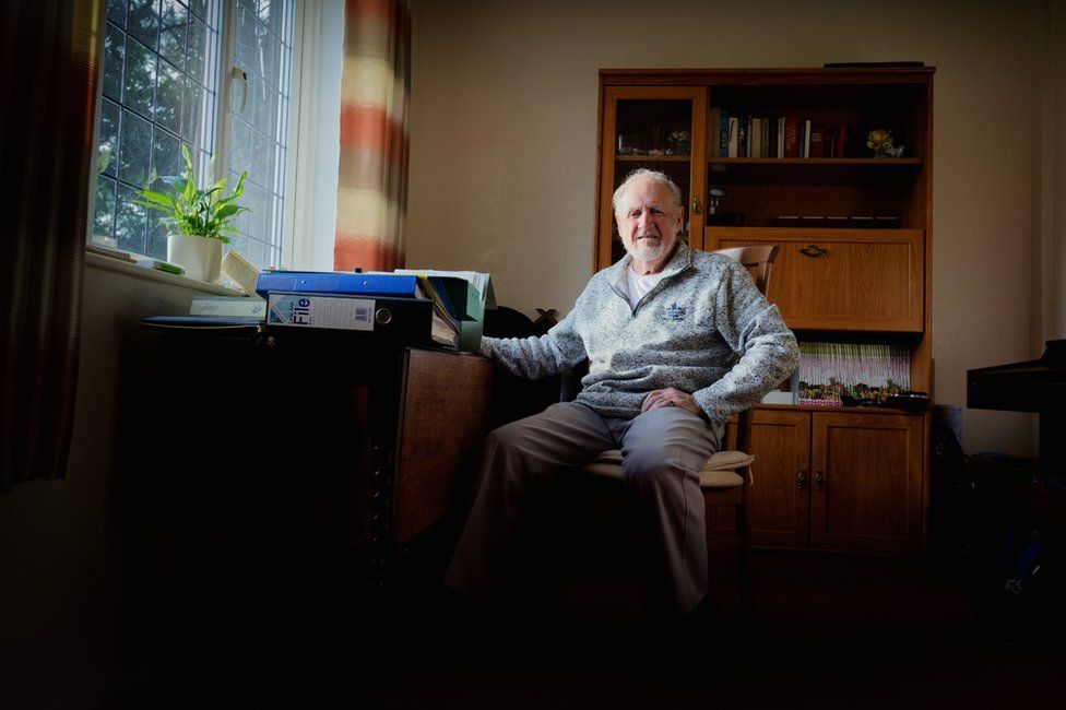 Jim Longstaff at home with some of his files