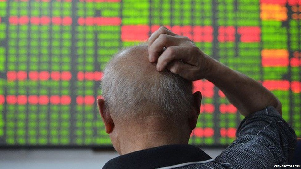 An investor scratches hiss head during he observing stock market at a stock exchange hall on July 1, 2015 in Hangzhou, Zhejiang Province of China.