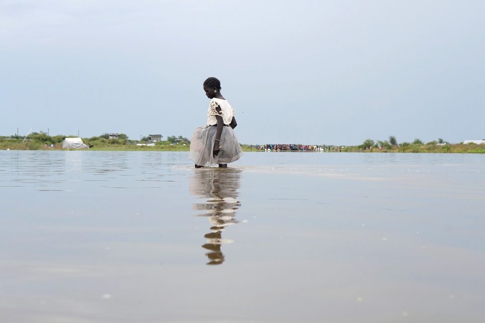 A girl walks in water after heavy rains and floods forced hundreds of thousands of people to leave their homes, in the town of Pibor, Boma state, South Sudan, November 6, 2019.Picture taken November 6, 2019
