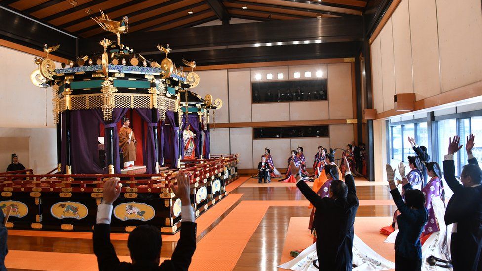 Emperor Naruhito stood inside the 6.5m-high Takamikura throne, with people surrounding it