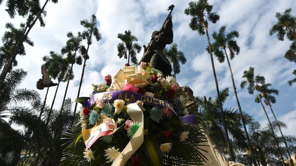 A wreath placed before the statue of one of the founding fathers of Colombia's independence, Joaquin de Cayzedo y Cuero at the main square in Cali, Colombia with a ribbon with an inscription that reads 'Farewell to War', on June 23, 2016